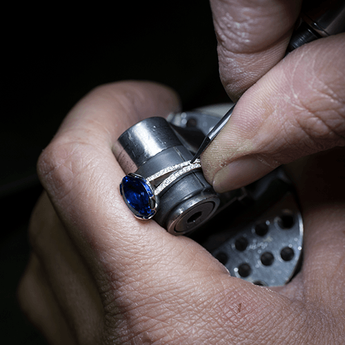 Hands setting a stone on the Wharton Goldsmith bench, St Albans
